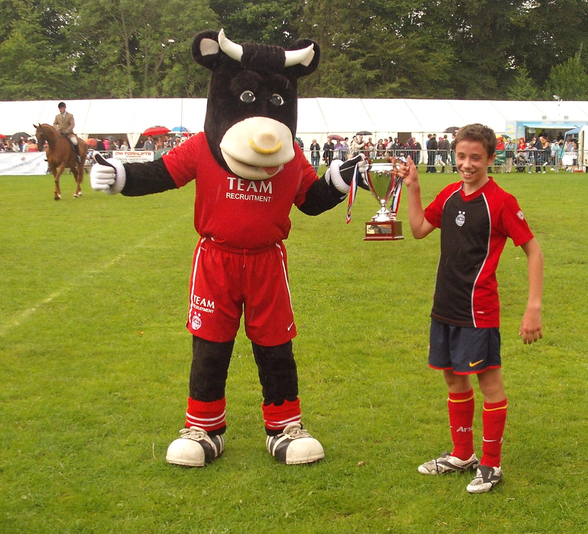Angus the Bull presenting winning cup